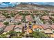 Picturesque aerial view shows homes with solar panels, beautiful landscaping, and mountain backdrop at 3412 Crystal Tower St, Las Vegas, NV 89129