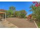 Large backyard featuring desert landscaping with rocks, bushes, and flowers, ideal for low-maintenance at 3412 Crystal Tower St, Las Vegas, NV 89129