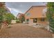 Back of house featuring patio, hot tub, and gravel area with mature landscaping and rock water feature at 3412 Crystal Tower St, Las Vegas, NV 89129