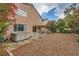 Rear view of a two-story home with a covered patio, hot tub and desert-style landscaping at 3412 Crystal Tower St, Las Vegas, NV 89129