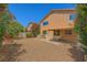 Spacious backyard with gravel, landscaping, and a covered patio, perfect for outdoor activities at 3412 Crystal Tower St, Las Vegas, NV 89129