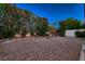 Tranquil backyard with mature landscaping, rock waterfall, and privacy wall at 3412 Crystal Tower St, Las Vegas, NV 89129