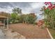 Picturesque backyard boasts a rock waterfall, mature foliage, and covered patio at 3412 Crystal Tower St, Las Vegas, NV 89129