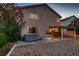 Back of house, hot tub and covered patio with rock waterfall and desert landscape at 3412 Crystal Tower St, Las Vegas, NV 89129