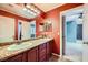 Bathroom featuring dual sinks, vanity and framed mirrors, and a doorway to an adjoining room at 3412 Crystal Tower St, Las Vegas, NV 89129