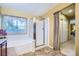 Bathroom with tile floors, walk-in shower, and large soaking tub with a large window at 3412 Crystal Tower St, Las Vegas, NV 89129