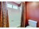 Well-lit bathroom featuring a bathtub with white tile surround and shower curtain, and a toilet at 3412 Crystal Tower St, Las Vegas, NV 89129
