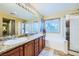 Bathroom with granite countertop, dual sinks, walk-in shower, and large soaking tub at 3412 Crystal Tower St, Las Vegas, NV 89129