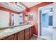 Bathroom featuring double sinks with granite counters, and access to adjacent bedroom at 3412 Crystal Tower St, Las Vegas, NV 89129