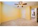 Bright bedroom with ceiling fan, plush carpeting and white door leading to hallway at 3412 Crystal Tower St, Las Vegas, NV 89129