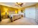 A cozy bedroom features a ceiling fan, light wooden furniture, and double door closet at 3412 Crystal Tower St, Las Vegas, NV 89129