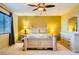 A charming bedroom boasts a window, ceiling fan, light wooden furniture, and soothing wall colors at 3412 Crystal Tower St, Las Vegas, NV 89129