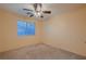 Bright bedroom with ceiling fan, neutral carpet, and a large window with blinds at 3412 Crystal Tower St, Las Vegas, NV 89129