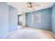 Cozy carpeted bedroom with ceiling fan, window, and mirrored closet doors at 3412 Crystal Tower St, Las Vegas, NV 89129