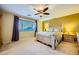Bedroom with carpet, fan and lighting, window with blinds and curtains, and a bed with nightstands at 3412 Crystal Tower St, Las Vegas, NV 89129