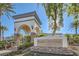 Elegant entrance to the Shadow Hills Club with a stone archway, manicured landscaping, and clear signage at 3412 Crystal Tower St, Las Vegas, NV 89129