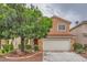 Charming two-story home featuring a well-manicured front yard with a mature shade tree and a two-car garage at 3412 Crystal Tower St, Las Vegas, NV 89129
