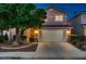 Inviting exterior view of a two-story home at dusk, showcasing the manicured landscaping and a two-car garage at 3412 Crystal Tower St, Las Vegas, NV 89129