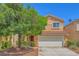 Charming two-story home with a red-tiled roof, large shade tree, and well-maintained landscaping at 3412 Crystal Tower St, Las Vegas, NV 89129