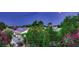Sunset view showcasing lush landscaping and home with roof solar panels at 3412 Crystal Tower St, Las Vegas, NV 89129