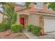 Inviting front entrance with a red door, desert landscaping, and exterior lighting fixtures at 3412 Crystal Tower St, Las Vegas, NV 89129