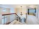 Hallway with a chandelier and iron banister overlooking the living room at 3412 Crystal Tower St, Las Vegas, NV 89129
