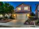 Inviting home with a two-car garage, attractive landscaping, and warm exterior lighting at dusk at 3412 Crystal Tower St, Las Vegas, NV 89129