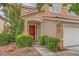 Lovely home with a red front door, clean landscaping, and an attached two-car garage at 3412 Crystal Tower St, Las Vegas, NV 89129