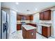 Open kitchen boasts stainless steel appliances, granite counters, and a center island at 3412 Crystal Tower St, Las Vegas, NV 89129