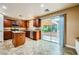 Kitchen features an island, wooden cabinetry, stainless steel appliances and a view to the backyard at 3412 Crystal Tower St, Las Vegas, NV 89129