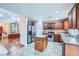 Modern kitchen with stainless steel appliances, granite countertops, and a functional island that transitions into the living room at 3412 Crystal Tower St, Las Vegas, NV 89129
