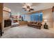 Open living room with fireplace, comfortable seating, and adjacent modern kitchen at 3412 Crystal Tower St, Las Vegas, NV 89129