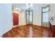 Large living room with hardwood floors, high ceilings, decorative windows, and a bright red front door at 3412 Crystal Tower St, Las Vegas, NV 89129