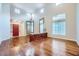 Spacious living area with hardwood floors, tall windows, and a red front door, offering a blend of elegance and comfort at 3412 Crystal Tower St, Las Vegas, NV 89129