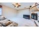 Carpeted living room with a fireplace, ceiling fan, and comfortable furnishings at 3412 Crystal Tower St, Las Vegas, NV 89129