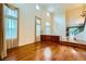 Spacious living room with hardwood floors, large windows, and a stunning staircase leading to upper levels at 3412 Crystal Tower St, Las Vegas, NV 89129