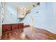Expansive living room boasts hardwood floors, a chandelier, and a built-in cabinet, seamlessly blending style with functionality at 3412 Crystal Tower St, Las Vegas, NV 89129