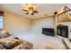 Spacious living room featuring a fireplace, ceiling fan, carpeting, and staircase at 3412 Crystal Tower St, Las Vegas, NV 89129