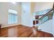 Open-concept living area with hardwood floors, high ceilings, natural light, and an open staircase at 3412 Crystal Tower St, Las Vegas, NV 89129