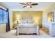 This beautiful bedroom features a large window, carpeted floors, a ceiling fan, and stylish decor at 3412 Crystal Tower St, Las Vegas, NV 89129
