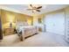 A staged bedroom with neutral carpet, closet and furnishings at 3412 Crystal Tower St, Las Vegas, NV 89129