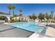 Inviting community pool with clear blue water, surrounded by palm trees and comfortable lounge chairs at 3412 Crystal Tower St, Las Vegas, NV 89129