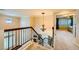 View of staircase leading to the upstairs with decorative chandelier and wood railing at 3412 Crystal Tower St, Las Vegas, NV 89129