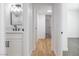 Bright bathroom featuring a single vanity with wood-look flooring and a decorative mirror at 3459 One Nation Ave, Las Vegas, NV 89121
