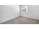 A clean bedroom features neutral carpet and a sunny window at 3459 One Nation Ave, Las Vegas, NV 89121