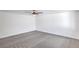 A basic bedroom features carpet, a ceiling fan, and white paint at 3459 One Nation Ave, Las Vegas, NV 89121