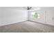 Spacious bedroom with carpet, fan and light, and a large window for natural light at 3459 One Nation Ave, Las Vegas, NV 89121