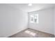 Neutral bedroom features a sunny window, carpet flooring, and white walls at 3459 One Nation Ave, Las Vegas, NV 89121