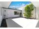 Bright courtyard with white walls, rock landscaping, small trees, and access door at 3459 One Nation Ave, Las Vegas, NV 89121