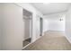 Hallway with closet doors, neutral carpets, and light fixtures at 3459 One Nation Ave, Las Vegas, NV 89121